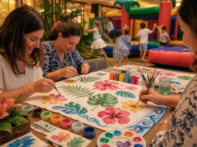 Adults painting colorful tropical designs onto fabric while kids play in the background