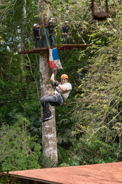Guest ziplining through the trees
