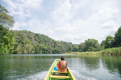 Boat ride through a green river landscape